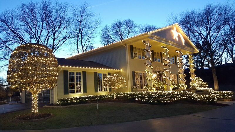 front of home at dusk with white xmas lights on trim